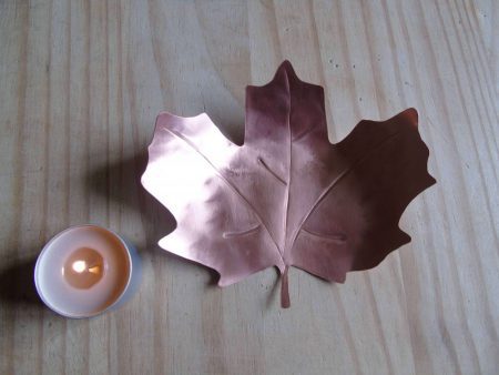 copper leaf shaped tealight holder with tealight at the side