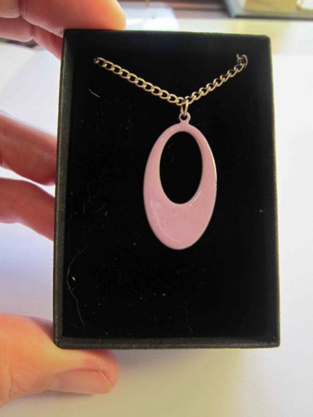 pink oval necklace with hole in presentation box