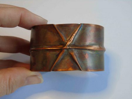 Cuff bracelet with crossing folds