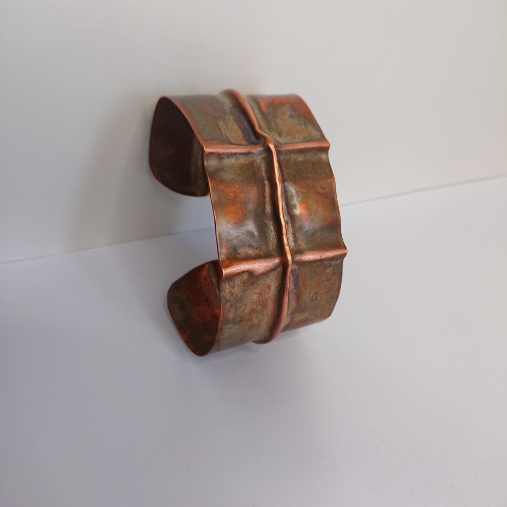 Chunky copper cuff bracelet or bangle with aged copper colour patina and fold formed design